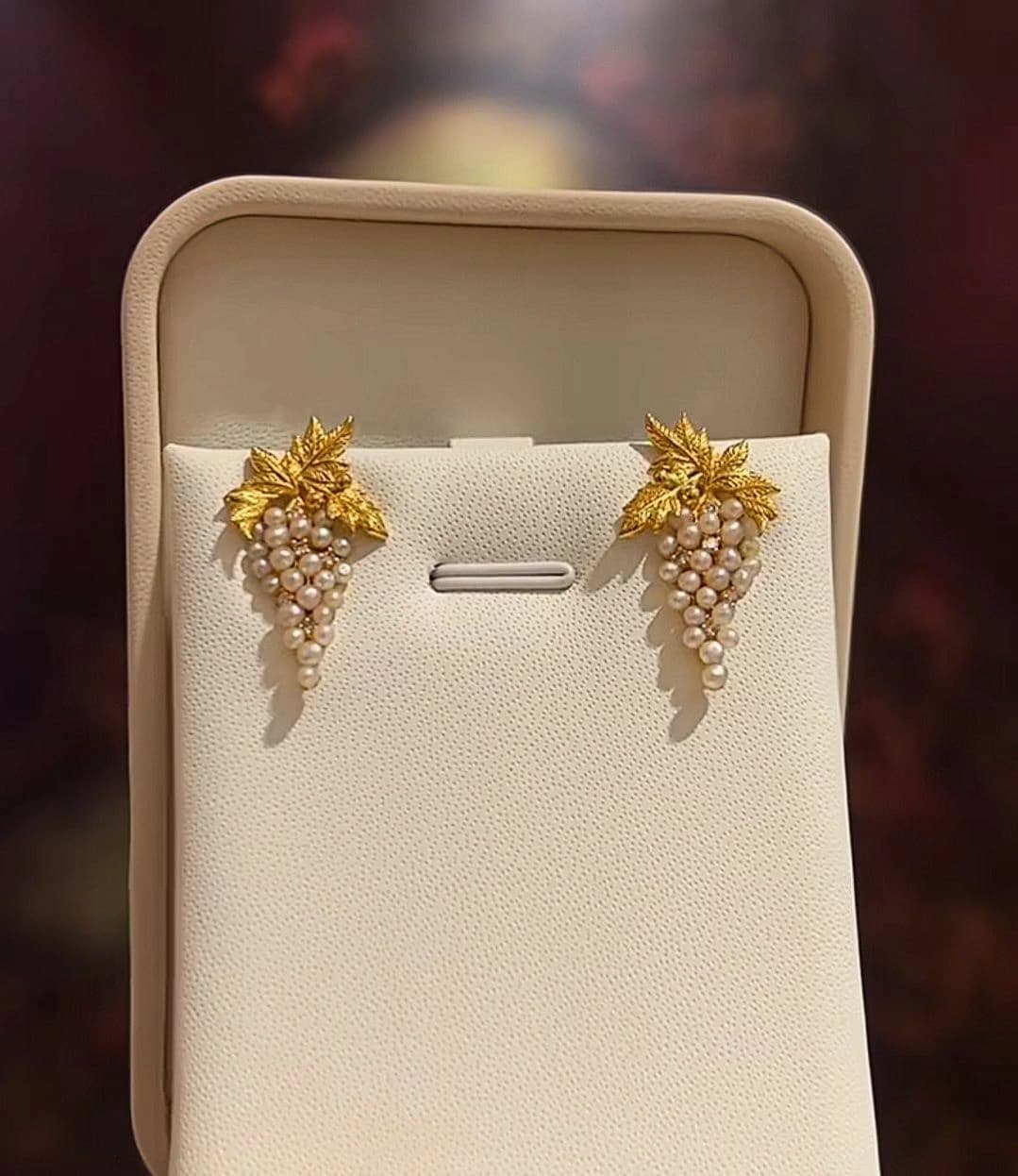 Pair of gold cluster bridal earrings presented in a jewellery box